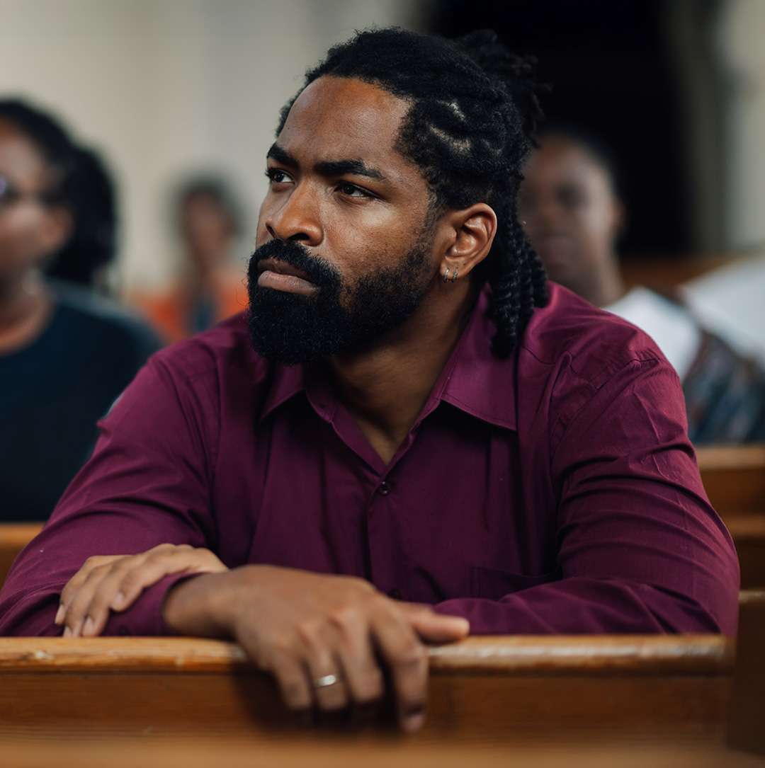 man in church pews listening